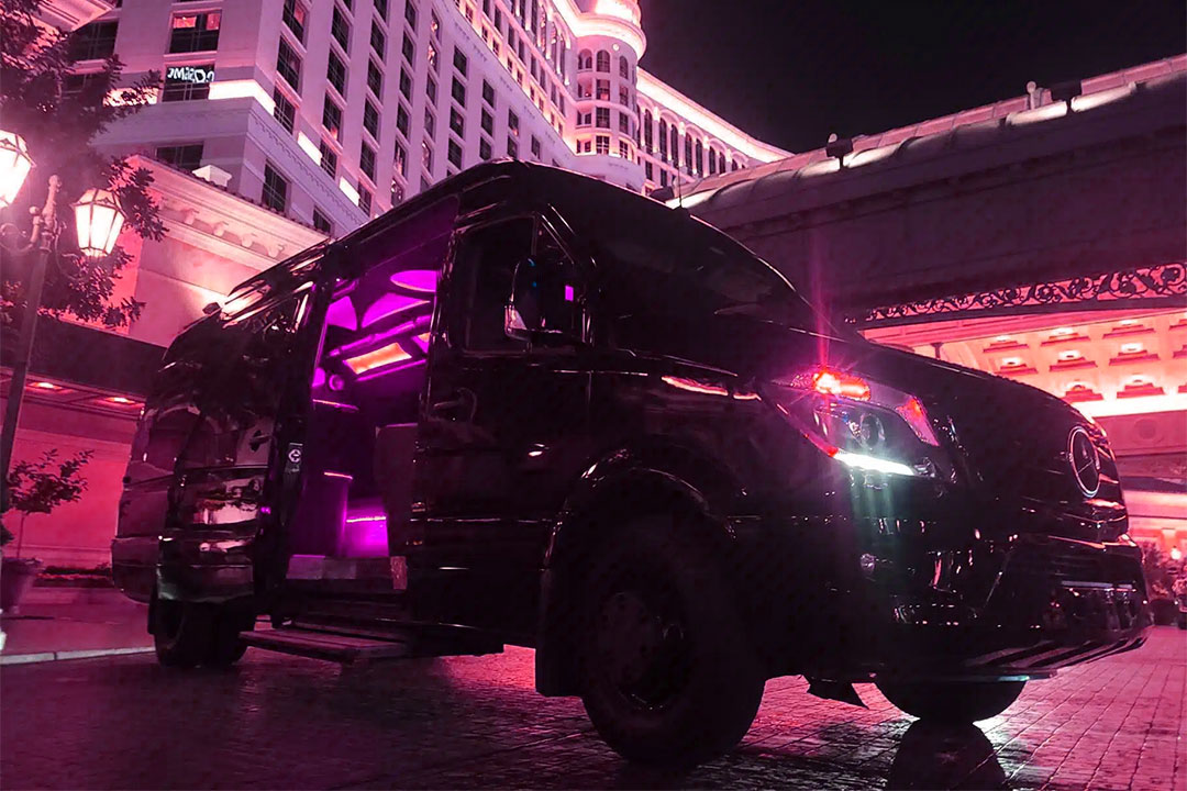 Black Mercedes Sprinter waiting outside a Las Vegas hotel for complimentary VIP transportation